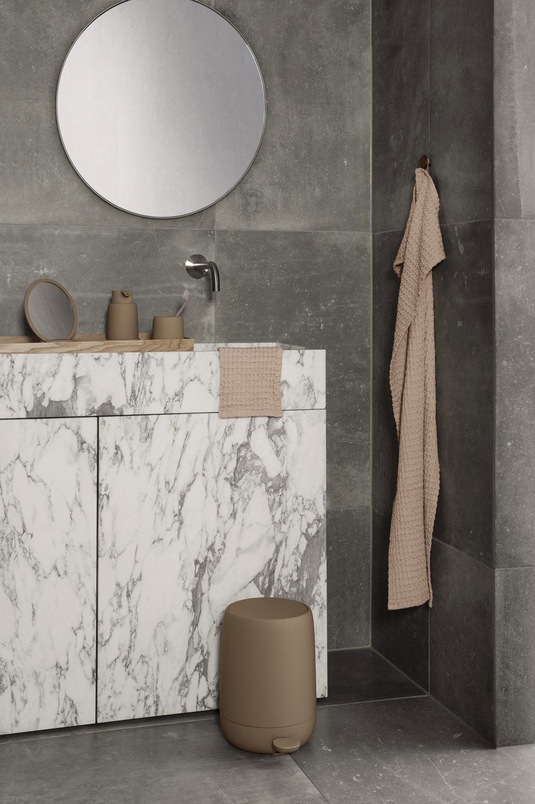 Elegant modern bathroom featuring marble countertops and neutral accessories.