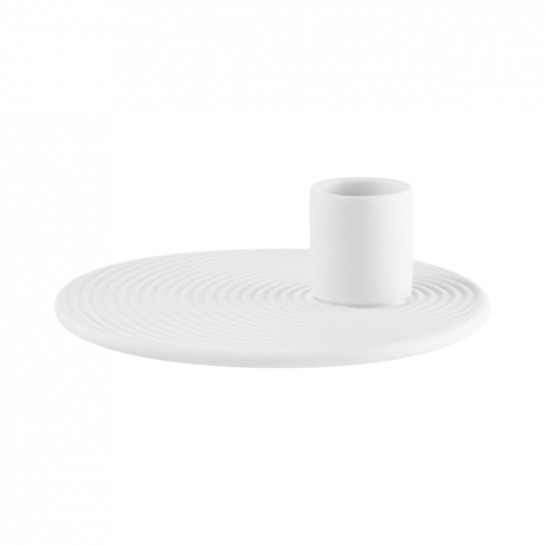 White ceramic plate with a circular pattern and a matching candle holder on top.
