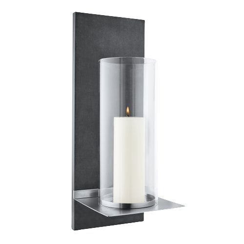 Modern wall-mounted lamp with a sleek design and warm white light illuminating a dark wall.