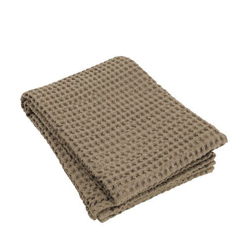 Cozy beige knitted blanket folded on a white background for home decor.