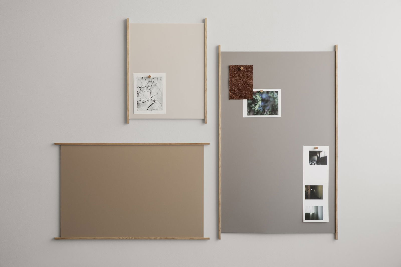Decorative wall display featuring framed art and photos on neutral-colored backgrounds.