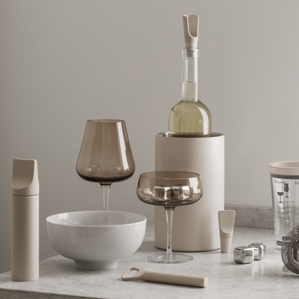 Stylish kitchenware collection featuring glassware, a wine bottle, and modern utensils.