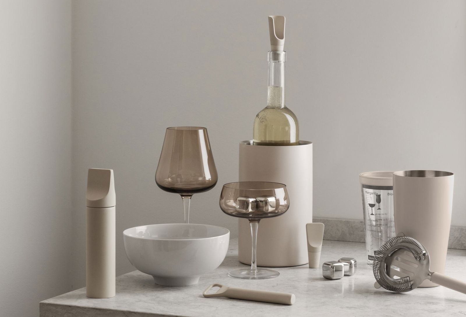 Stylish kitchenware collection featuring glassware, a wine bottle, and modern utensils.