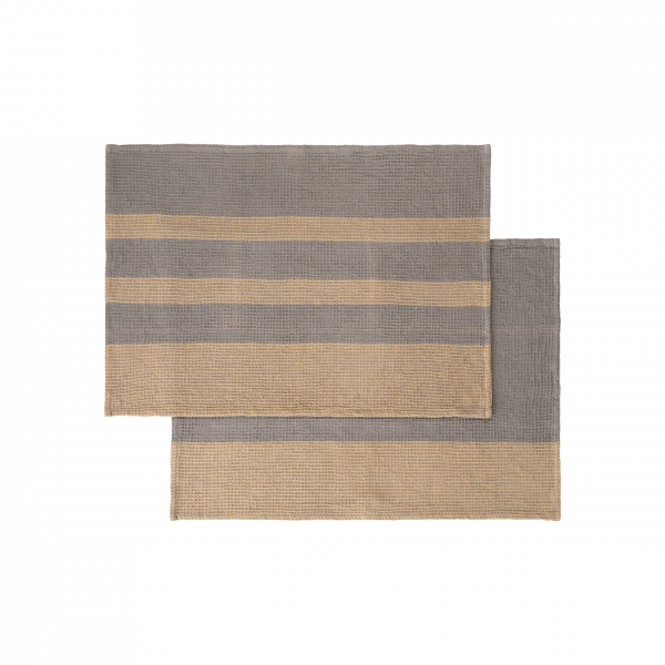 Stylish woven placemats in grey and beige stripes for modern dining decor.