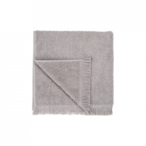 Soft gray cotton towel with fringed edges, perfect for bathrooms and spas.