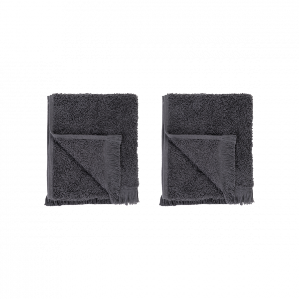 Two plush gray towels neatly folded on a black background.