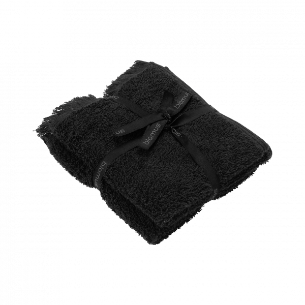 Soft black towel set elegantly tied with a ribbon, perfect for luxury bath experiences.