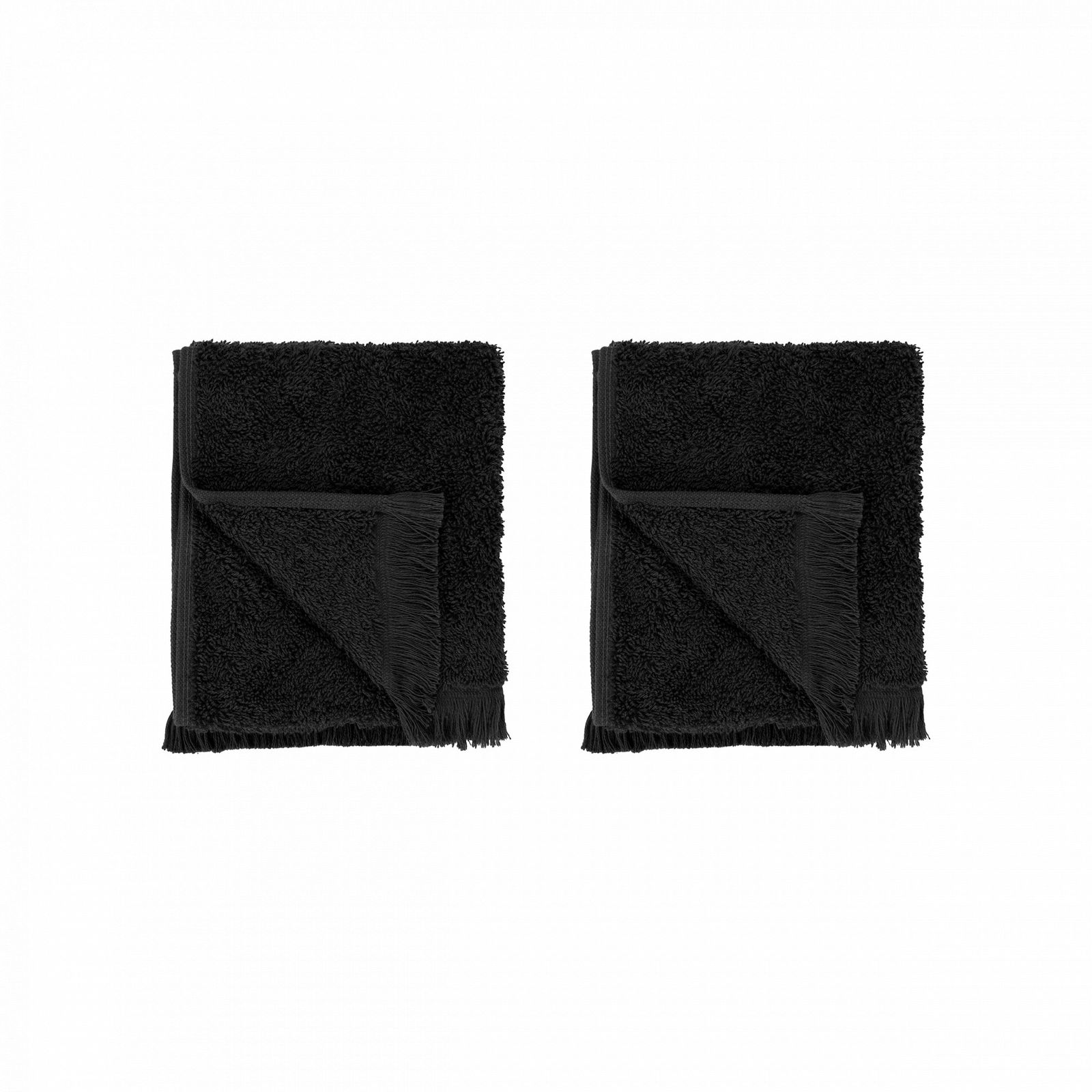 Two plush black towels folded neatly on a black background.