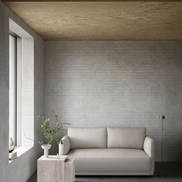 Modern living room featuring a minimalist sofa, natural light, and stylish decor elements.