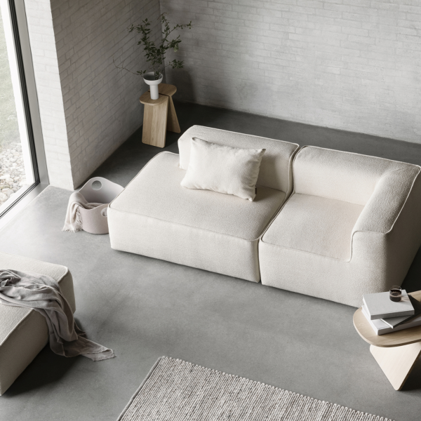 Modern neutral living room with a cozy sectional sofa and minimalist decor.