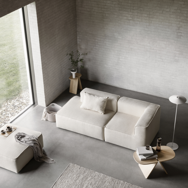 Modern minimalist living room with a cozy white sofa, wooden table, and stylish decor.