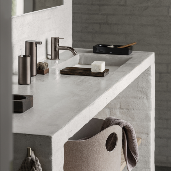 Modern bathroom vanity with sleek fixtures and minimalist decor, featuring a concrete sink.