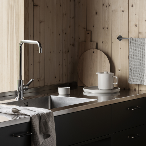 Modern kitchen with wooden walls, stainless steel sink, and minimalist dishware.