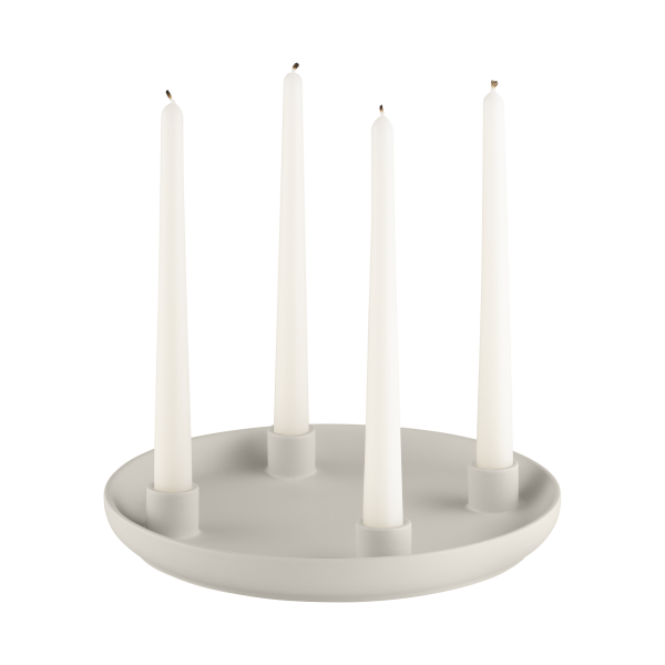 Elegant white candle holder with four tall candles in a minimalistic design.