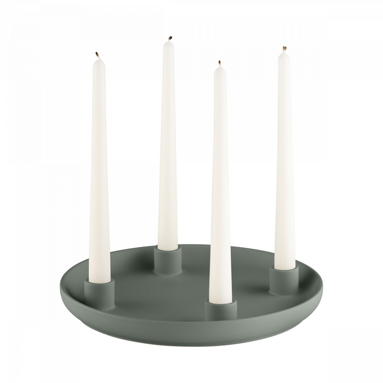 Elegant green candle holder with four tall white candles for a modern home decor.