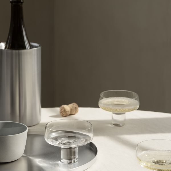 Elegant champagne glasses on a table with a bottle and cork, perfect for celebrations.