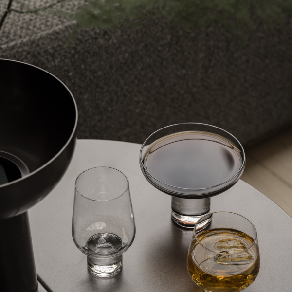 Elegant drinkware with assorted cocktails on a stylish table in a modern setting.