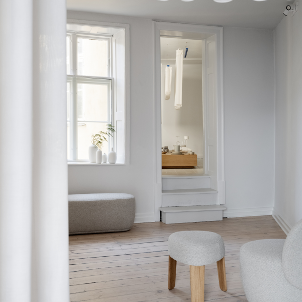 Minimalist interior featuring natural light and modern furniture in a serene setting.