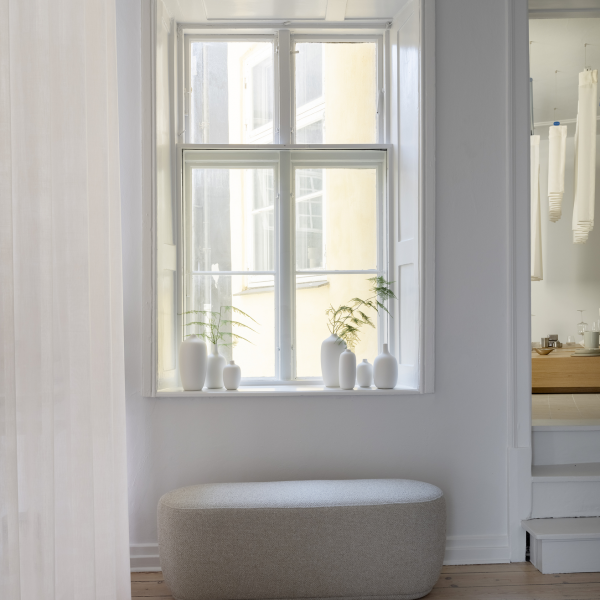 Bright interior with a minimalist window display and modern decor in a serene space.