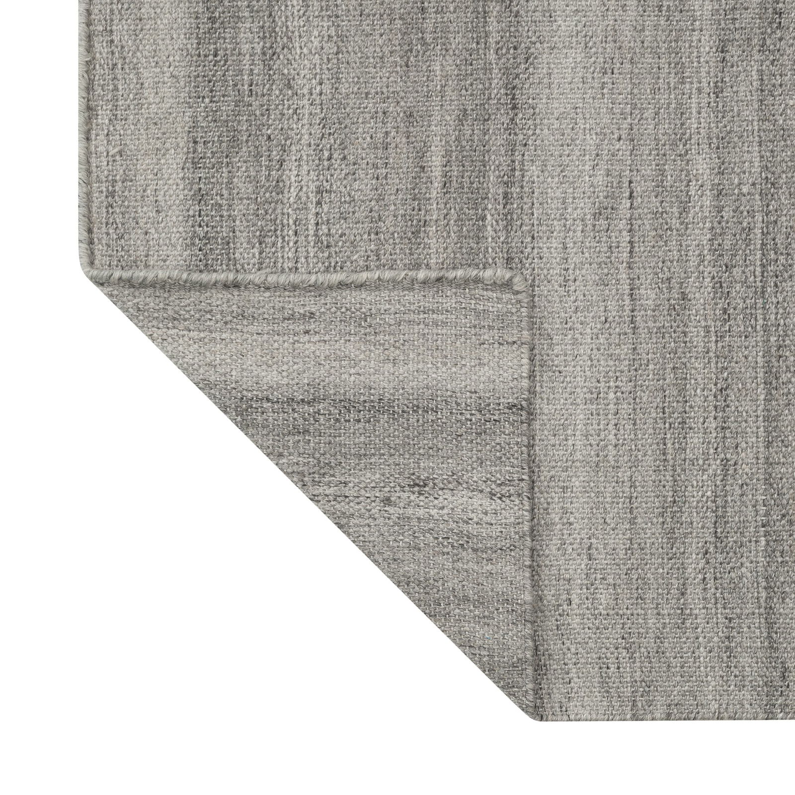 Strukturierter grauer Teppich in der Ecke, der ein modernes Design präsentiert, perfekt für zeitgenössische Innenräume.