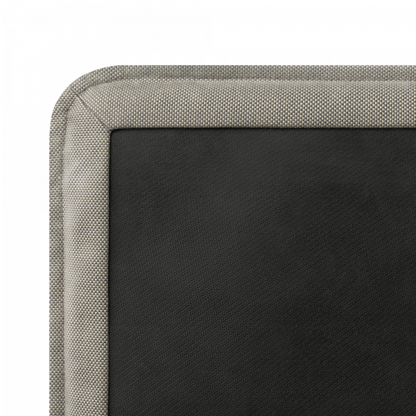 Close-up of a textured black leather surface with a light gray fabric border.