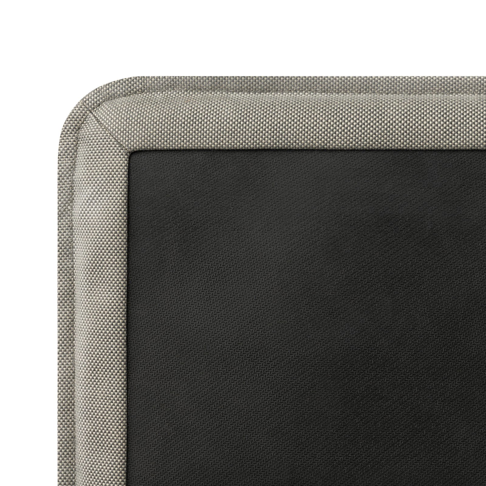 Close-up of a textured black leather surface with a light gray fabric border.