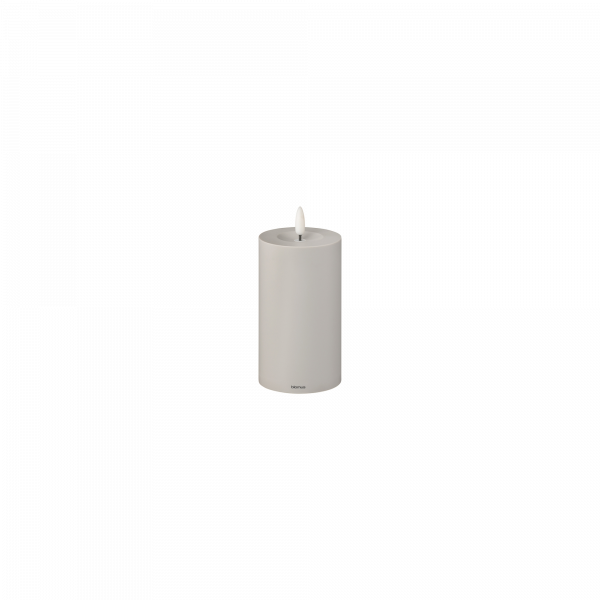 White cylindrical decorative candle with a sleek design.