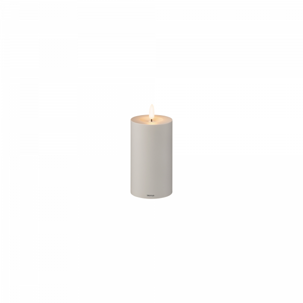 Elegant white candle with a soft glow, perfect for home decor or relaxation ambiance.
