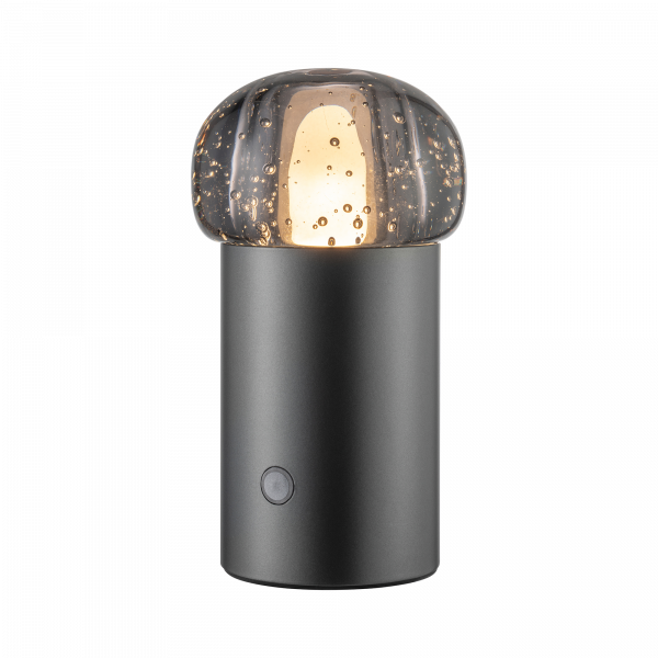 Moderne schwarze Tischlampe mit einem strukturierten Glasschirm und warmem, glänzendem Licht.