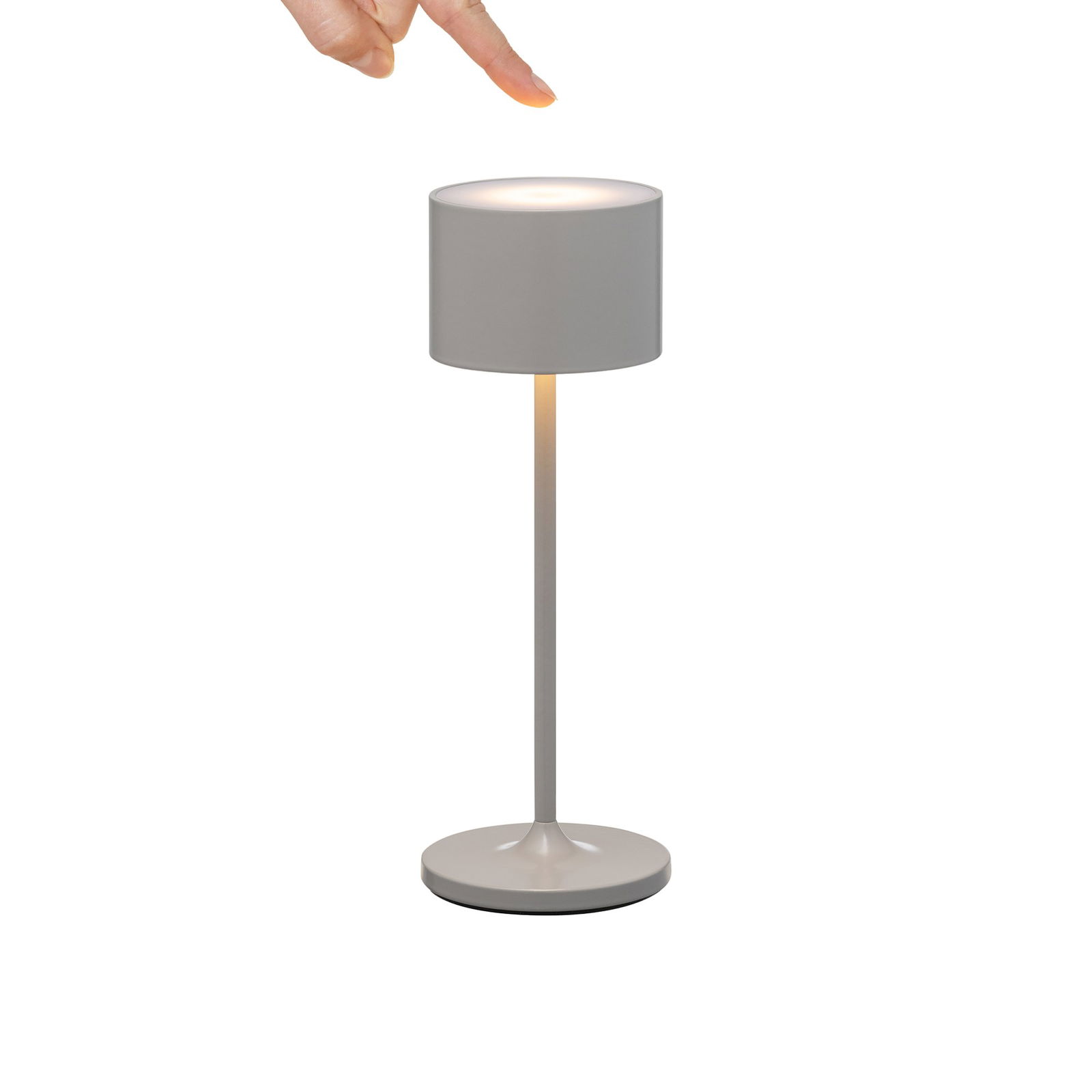 Hand, die eine moderne weiße Tischlampe mit einem zylindrischen Schirm anpasst.