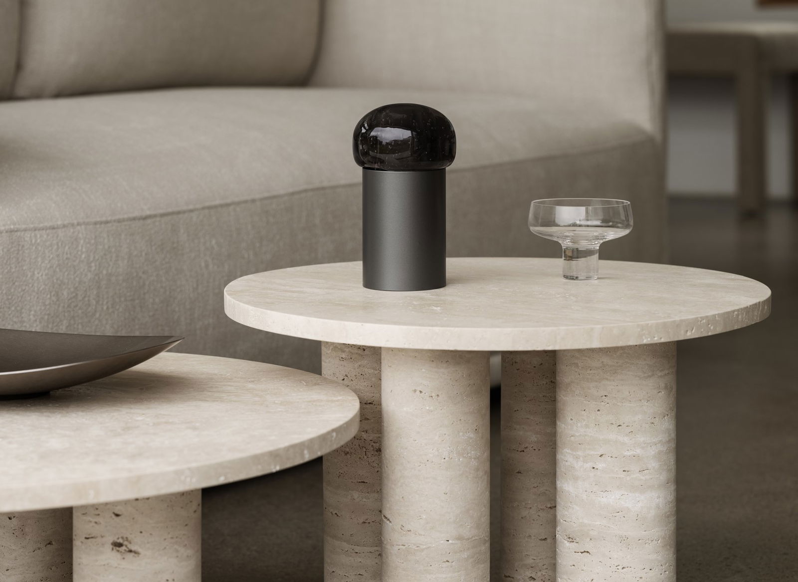 Moderne Kaffeetischdekoration mit einer stilvollen schwarzen Kuppellampe und einer eleganten Glasschüssel.