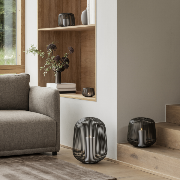 Modern living room with stylish black wire lamps and minimalist furniture accents.