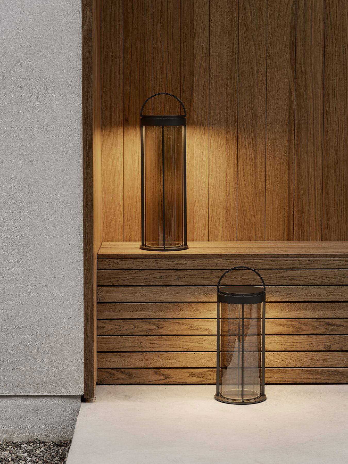 Elegante Glaslaternen mit schwarzen Akzenten, die einen Holzregal-Hintergrund beleuchten.