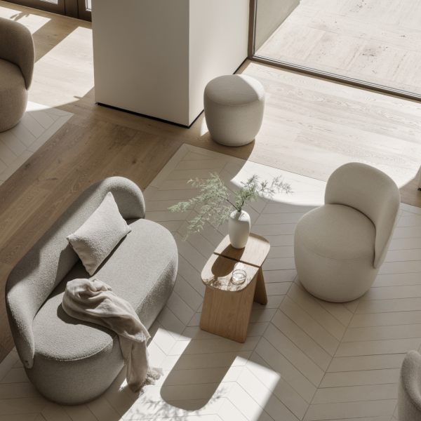 Modern living room with minimalist furniture in warm tones and natural lighting.