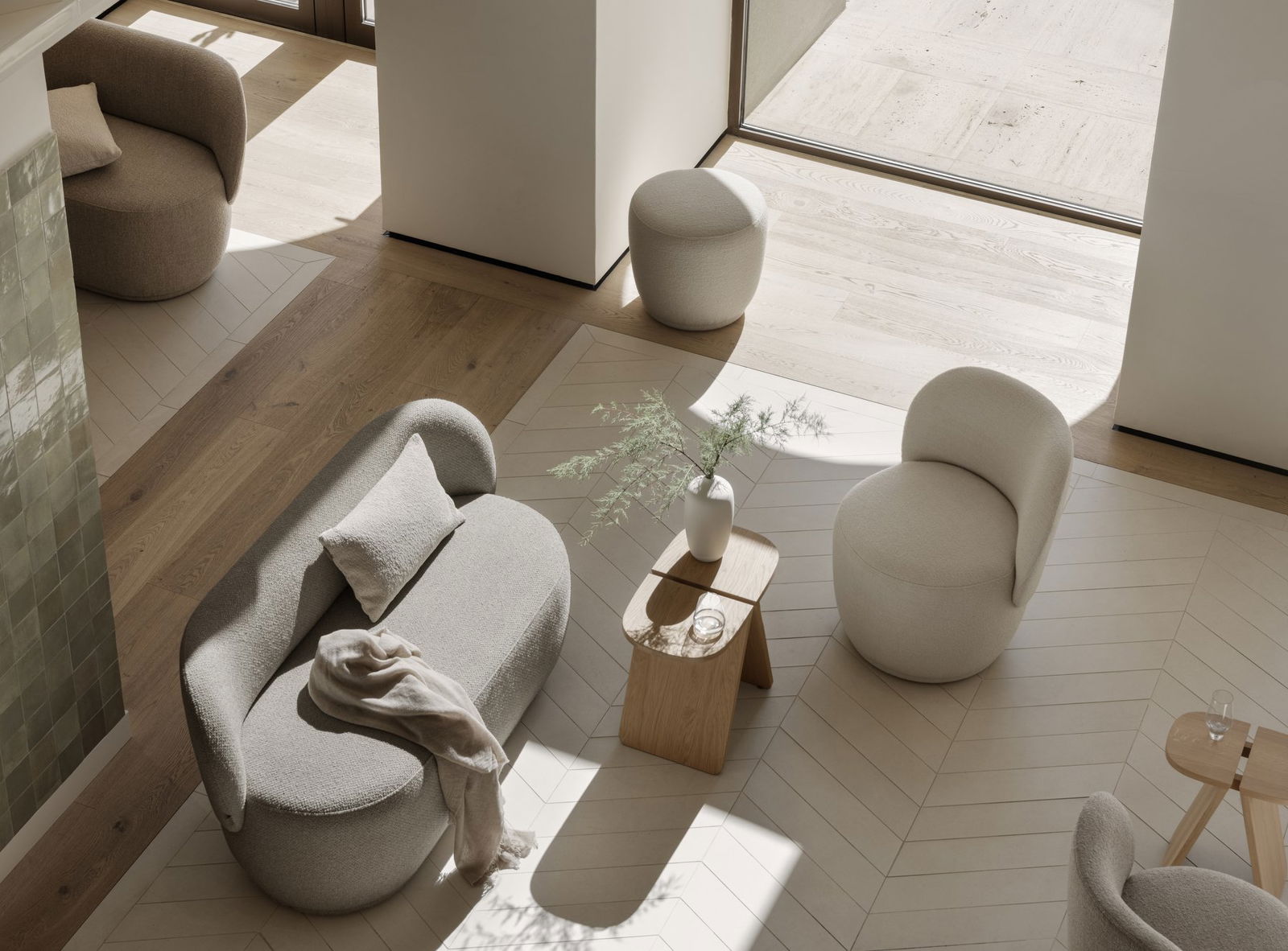 Modern living room with minimalist furniture in warm tones and natural lighting.