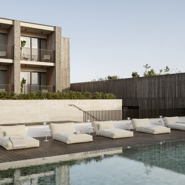 Luxurious poolside lounge area with modern sunbeds and elegant wooden architecture.