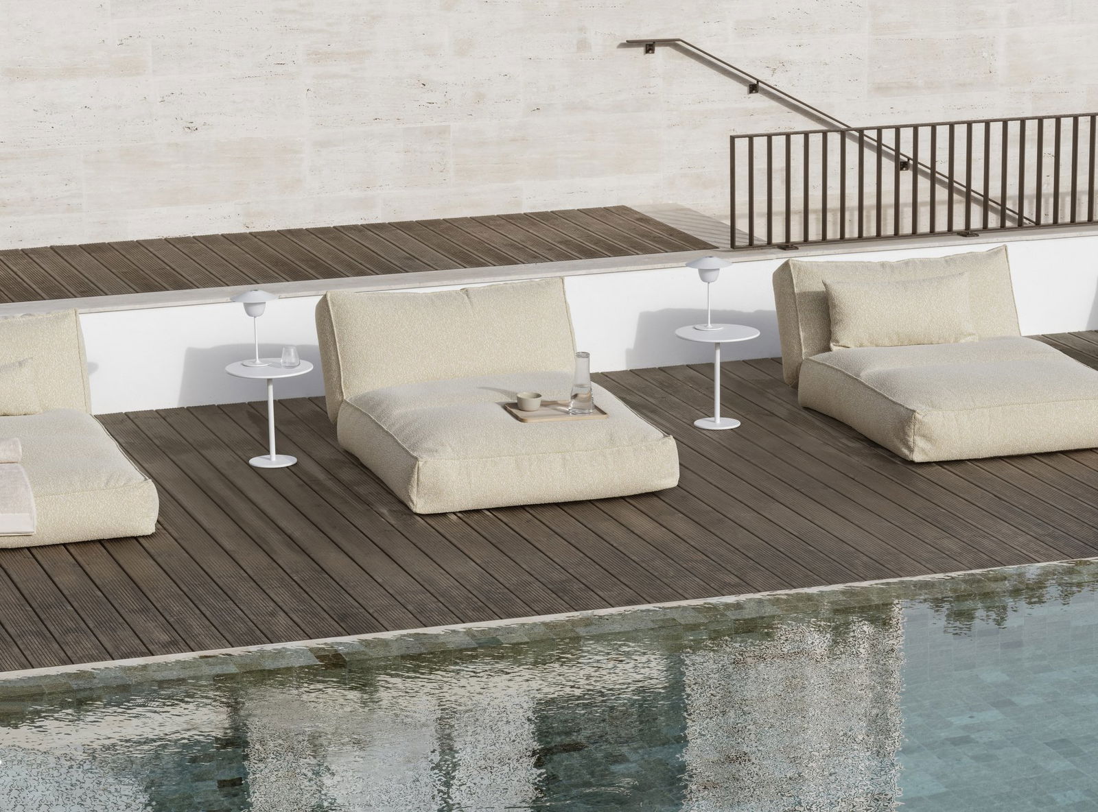 Stylish outdoor lounge chairs by a pool, perfect for relaxation and summer vibes.