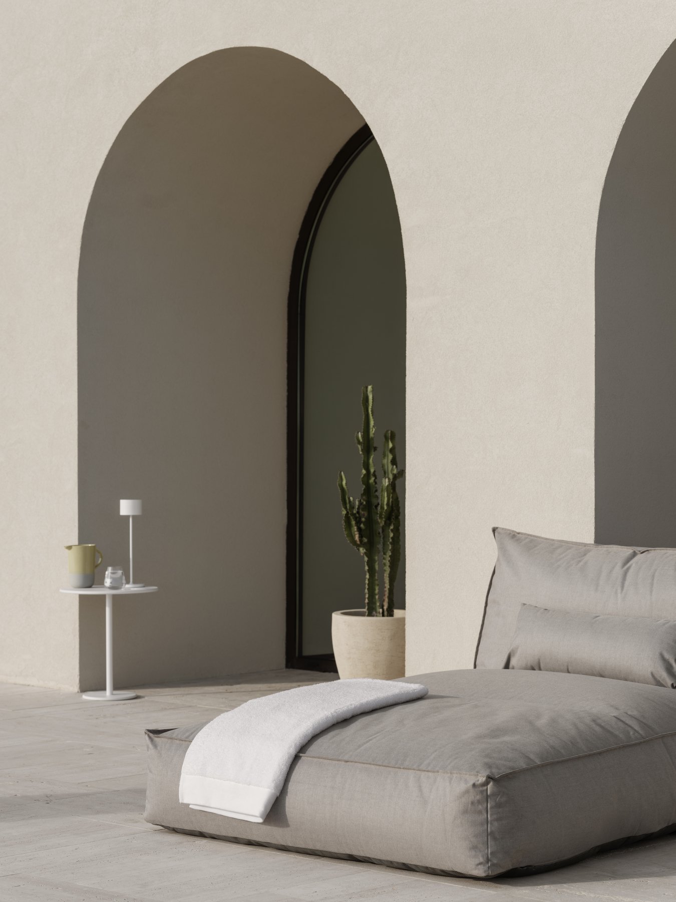 Moderner Außensitzbereich mit einer neutralen Farbpalette und minimalistischer Dekoration.