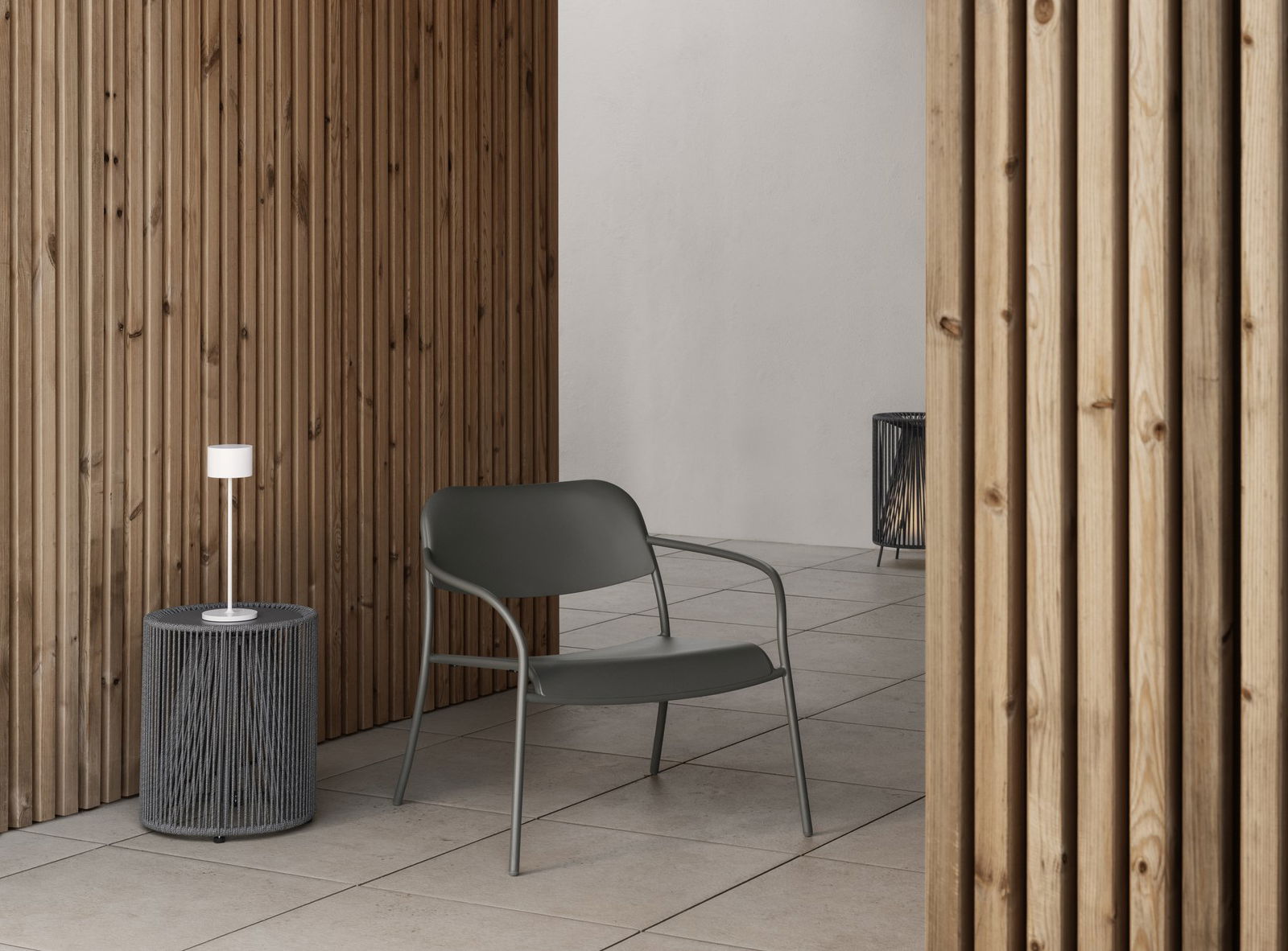 Modern outdoor chair in a minimalist setting with wooden walls and stylish lighting.