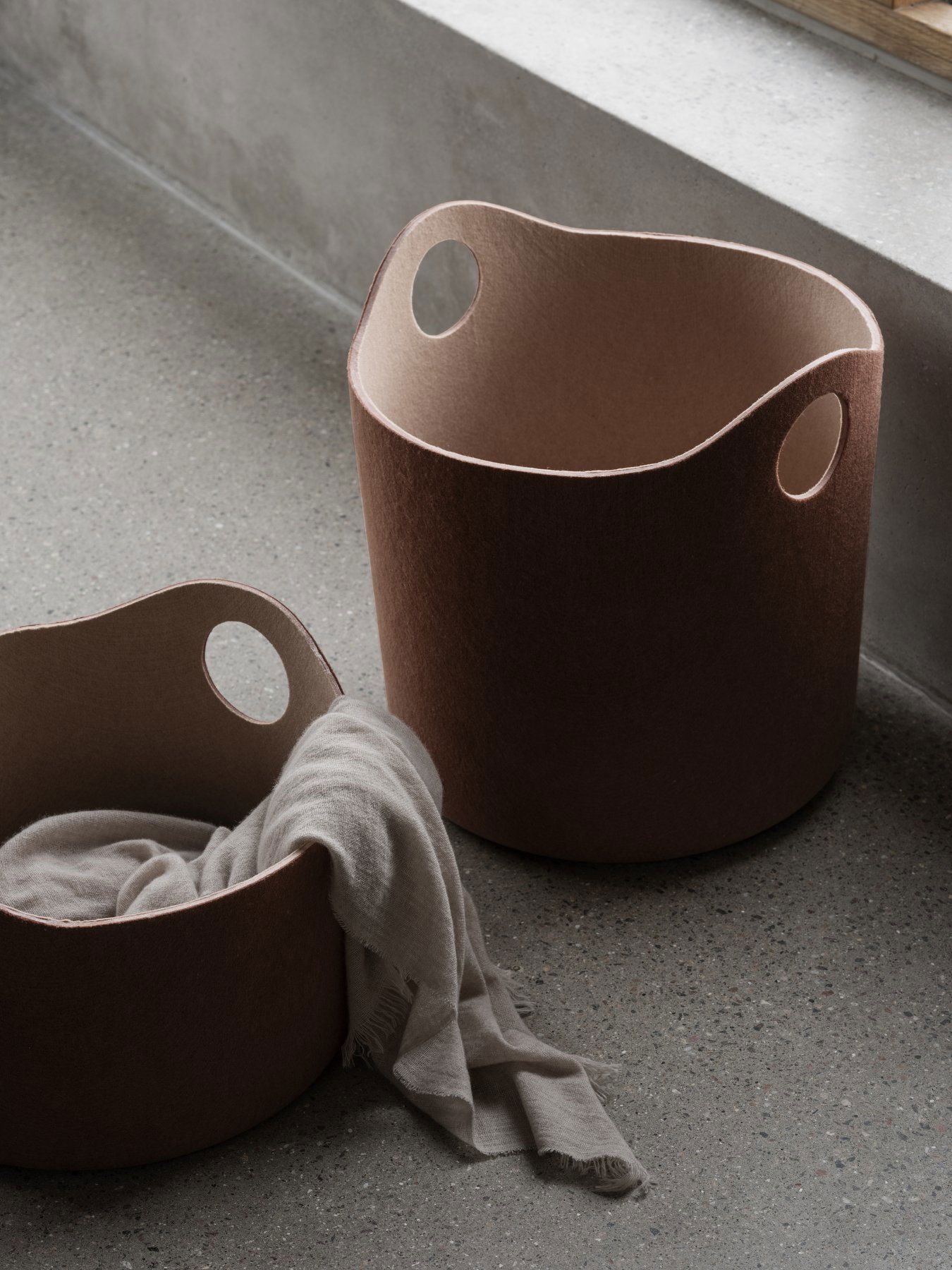 Stylish felt storage baskets with handles, perfect for organizing home spaces.