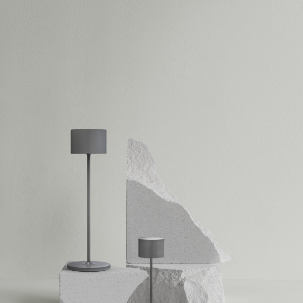 Modern table lamps on abstract geometric stone bases against a minimalist wall.