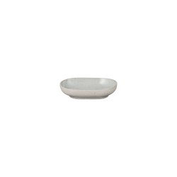 Minimalist ceramic dish with speckled design, perfect for modern table settings.