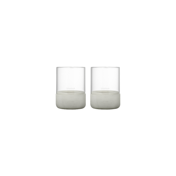 Set of two modern glass candles with elegant concrete bases for stylish decor.