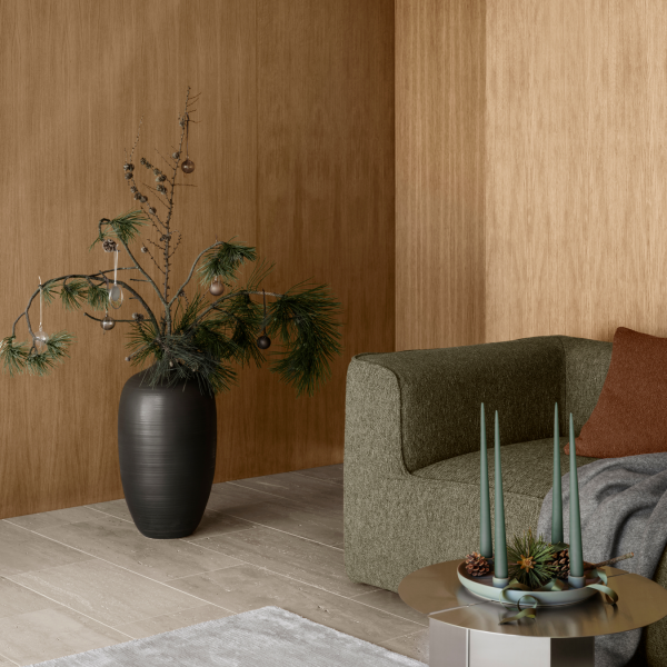 Modern living room decor featuring a stylish sofa, decorative plants, and festive accents.