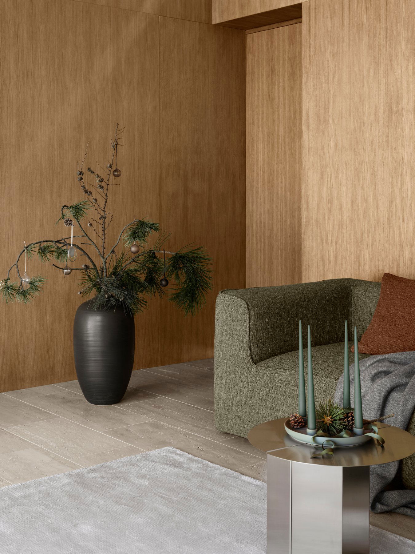 Modern living room decor featuring a stylish sofa, decorative plants, and festive accents.