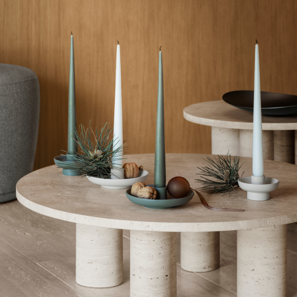 Elegant table setting with taper candles, decorative bowls, and modern design accents.