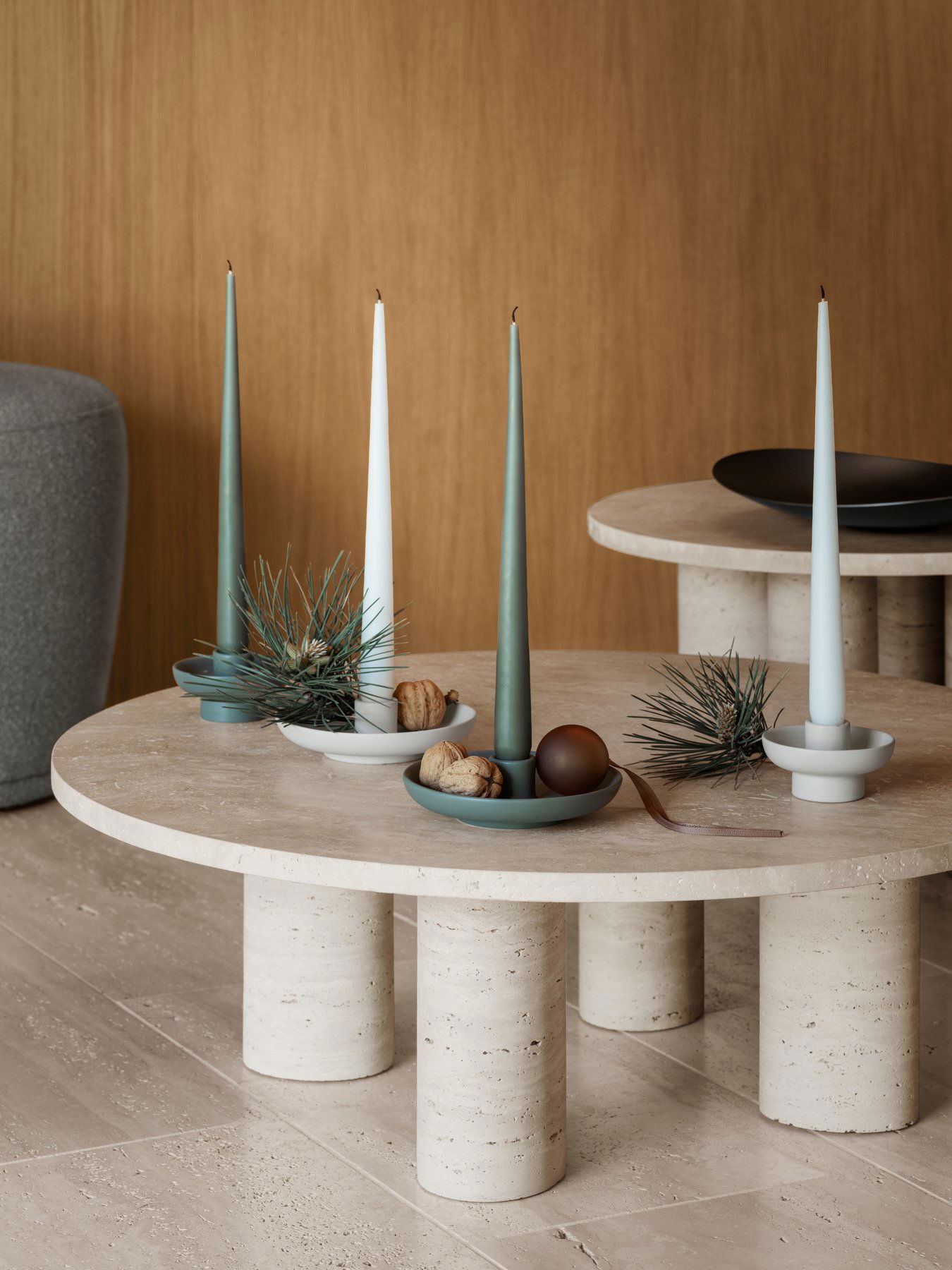 Elegant table setting with taper candles, decorative bowls, and modern design accents.