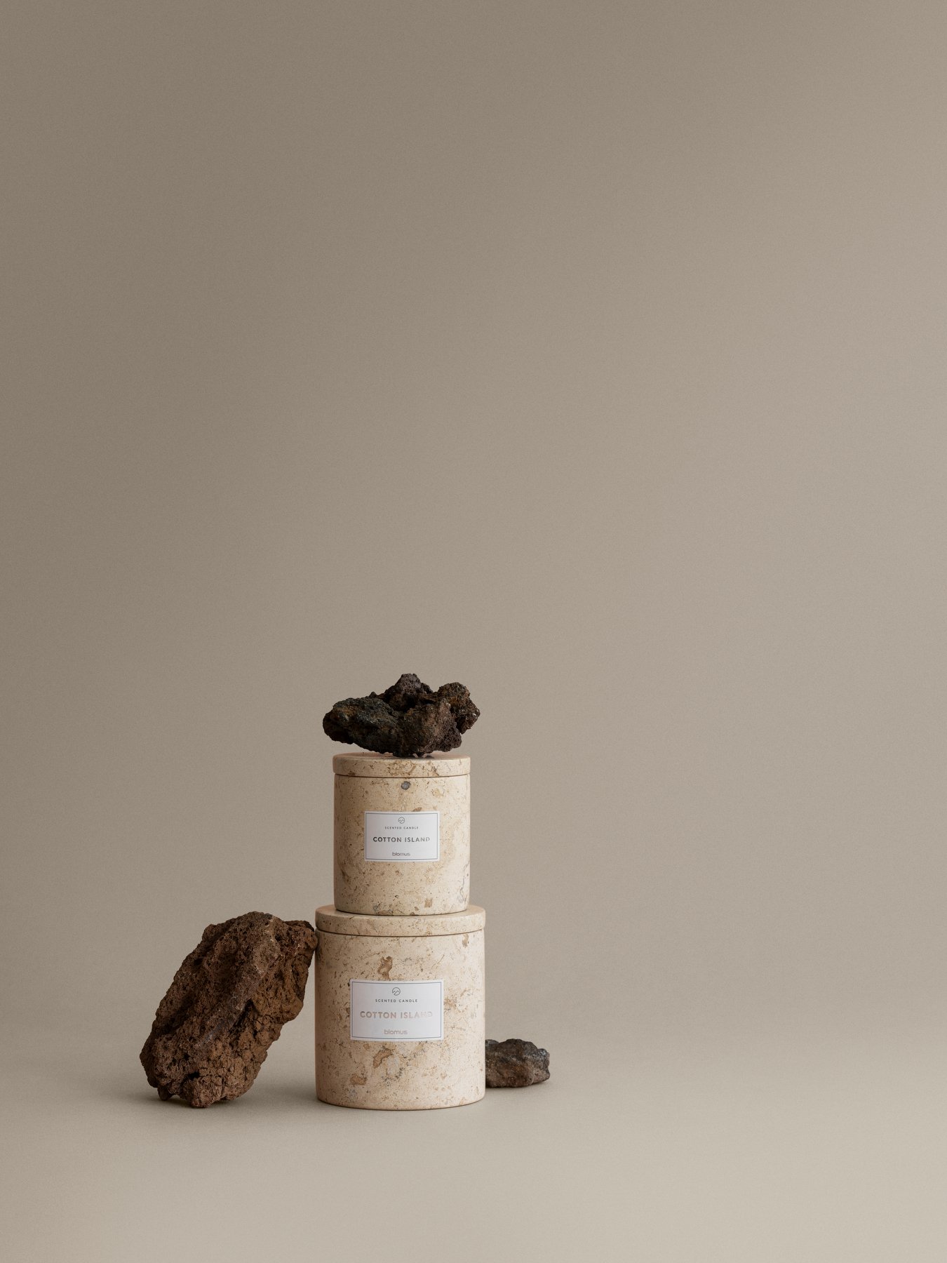 Elegant stacked natural stone candle holders on a neutral background showcasing minimalist design.