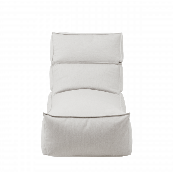 Cozy white lounge chair with a modern design on a black background.