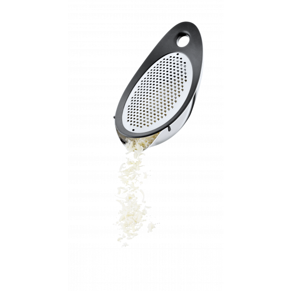 Stainless steel grater with shredded cheese falling out against a black background.